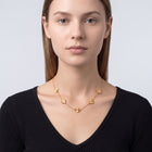 Portrait of a woman wearing the Adèle Gold Necklace