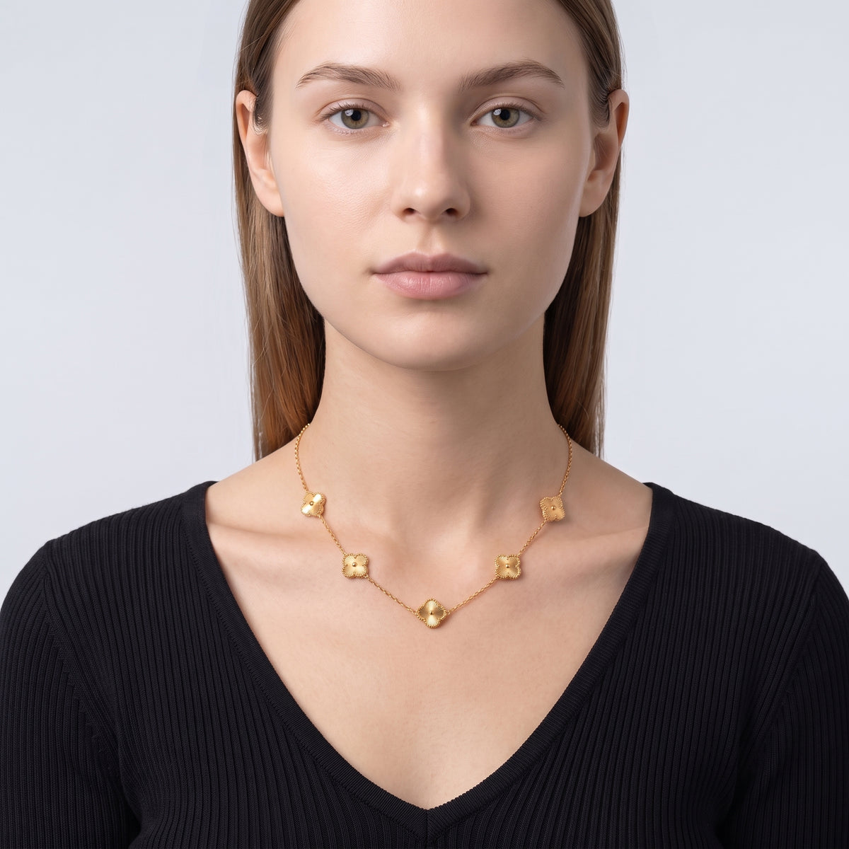 Portrait of a woman wearing the Adèle Gold Necklace