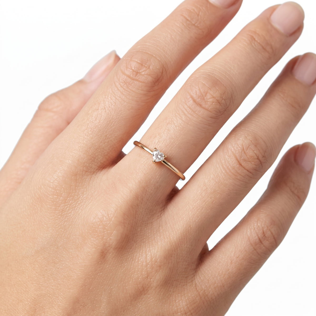 Hand wearing Lelice gold heart crystal solitaire ring Aimée