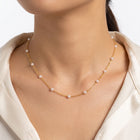 Close-up of the Lelice Amalfi Pearl Necklace in gold at the collarbone