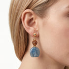 Close-up of the Lelice Amara Blue Marbled Acrylic Statement Drop Earrings in gold on the ear