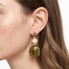 Close-up of the Lelice Amara Green Marbled Acrylic Statement Drop Earrings in gold on the ear