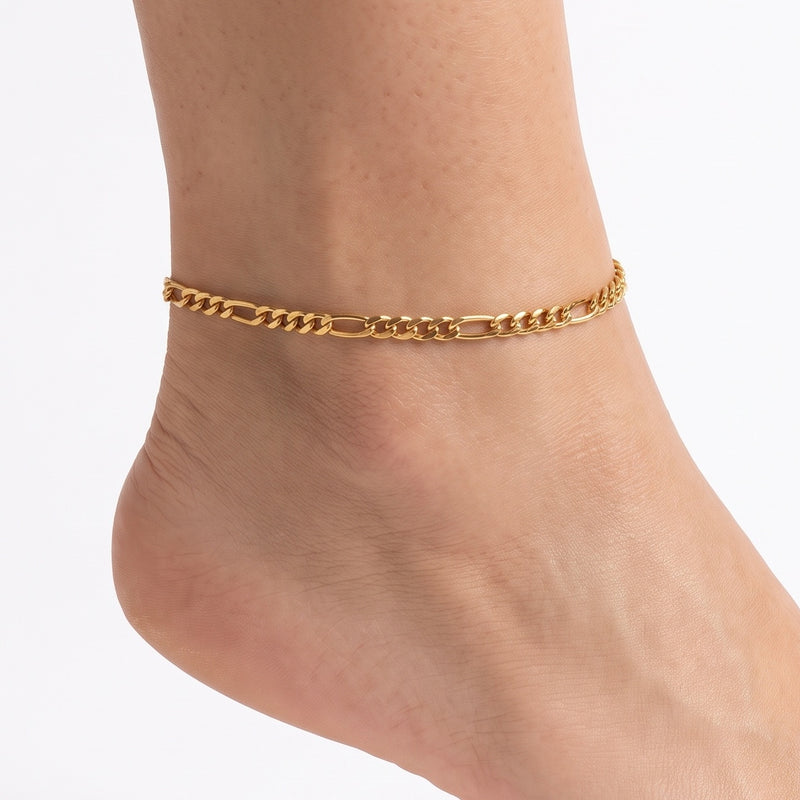 Close-up of the Lelice Amara Link Chain Anklet in gold on a woman's ankle