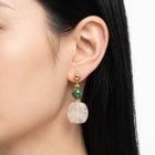 Close-up of the Lelice Amara White Marbled Acrylic Statement Drop Earrings in gold on the ear