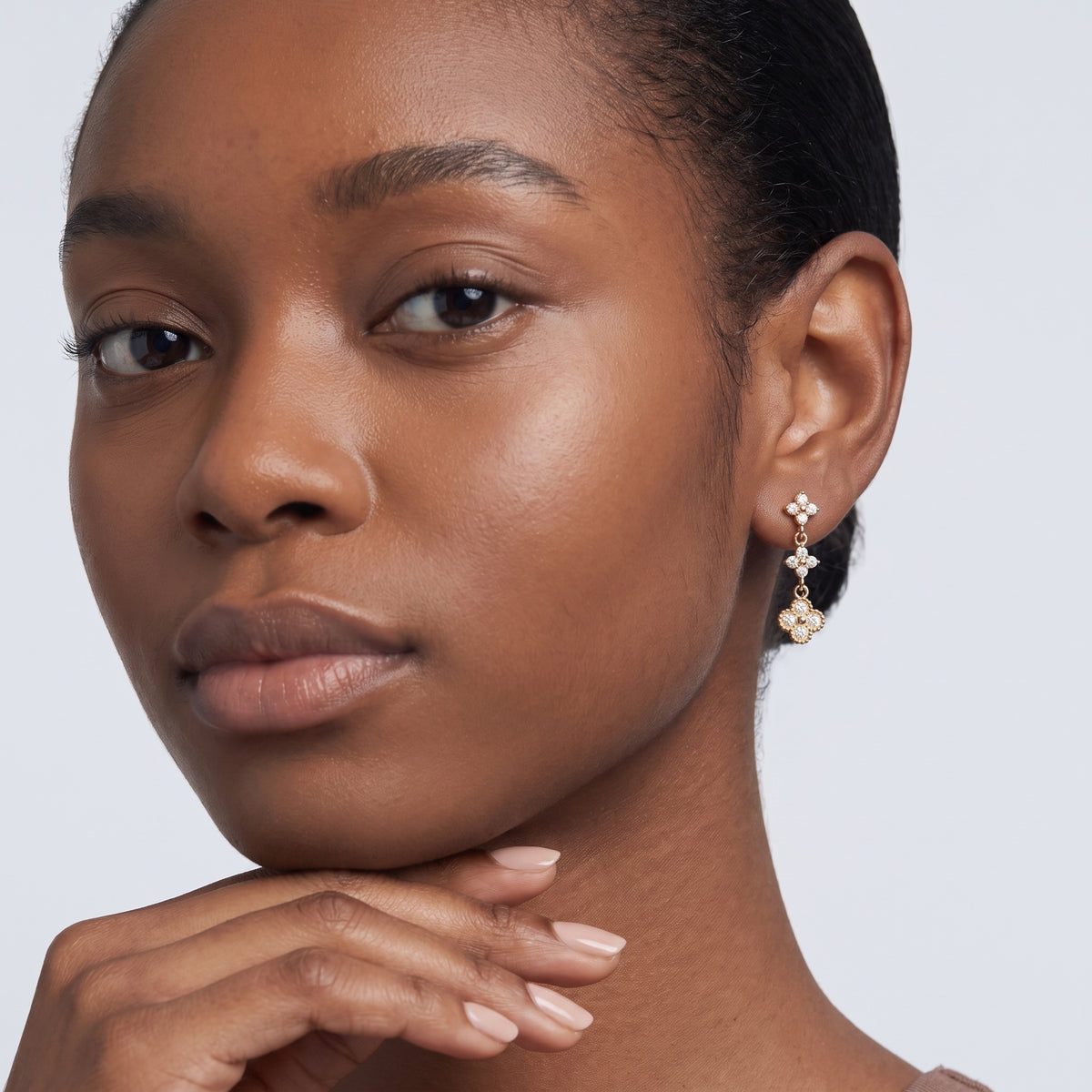 Model wearing the Lelice Ambre Glow Earrings in gold, hand at the chin