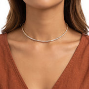 Close-up of the Lelice Amira Crystal Choker in gold at the collarbone