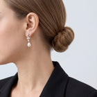 Model wearing the Lelice Artemis Gold Pearl Drops, low bun, ear and neck