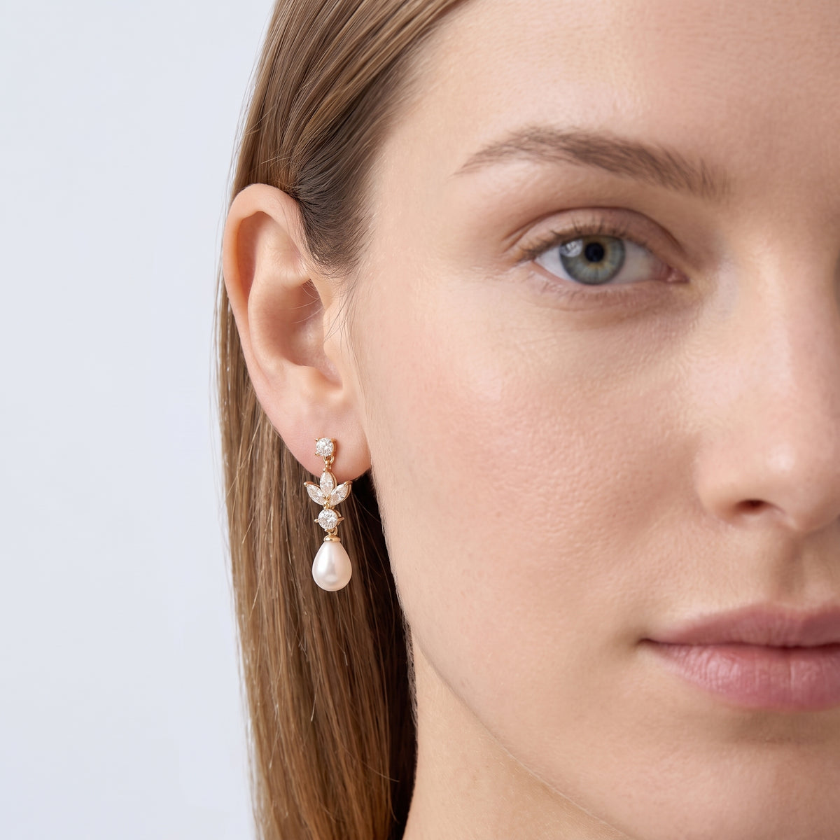 Model wearing the Lelice Artemis Gold Pearl Drops, one-eye face close-up