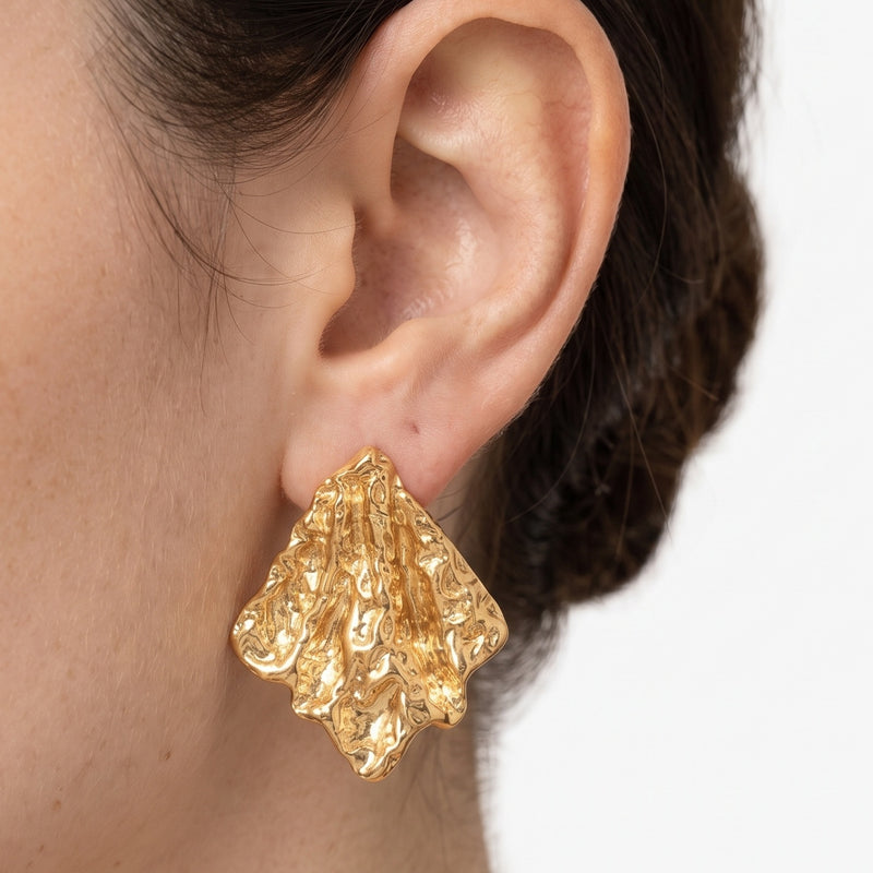 Close-up of the Lelice Artisan Ripple Studs in gold on the ear