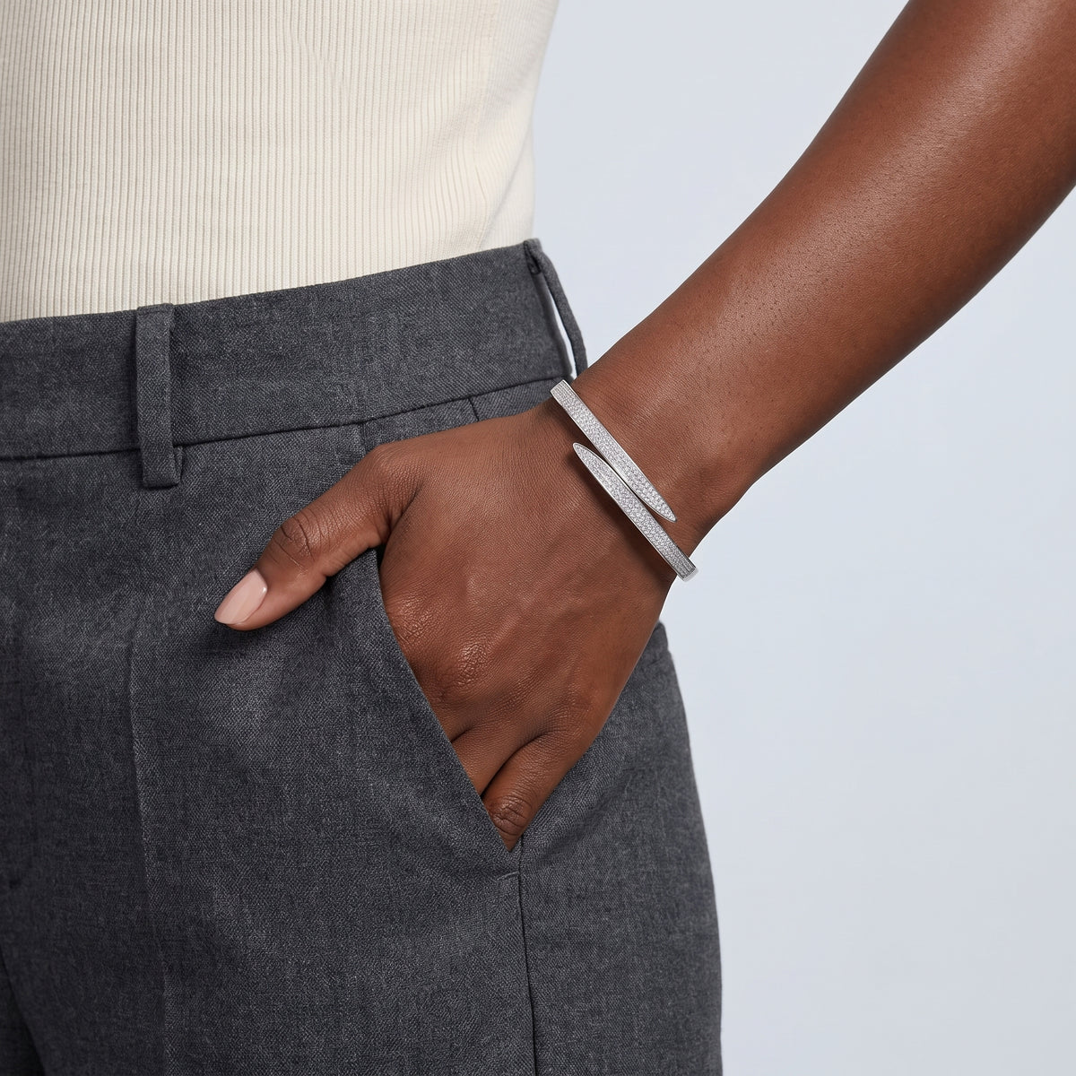 Model wearing the Lelice Astrid Silver Bangle, hand in the trouser pocket