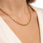 Close-up of Aurélie gold box chain necklace resting on the collarbone