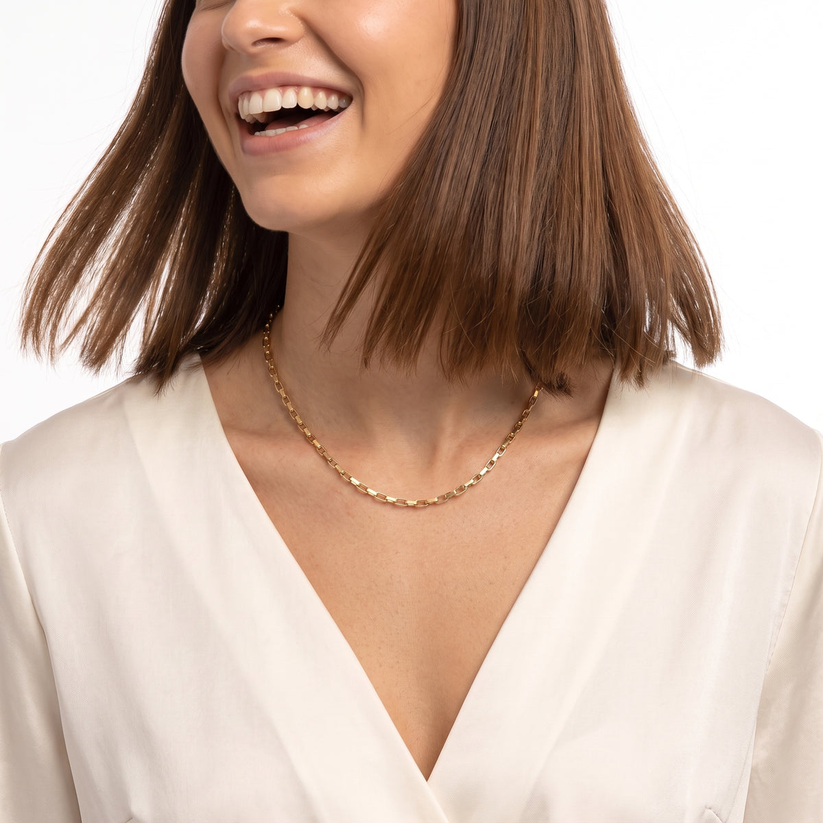 Laughing woman wearing Aurélie gold box chain necklace