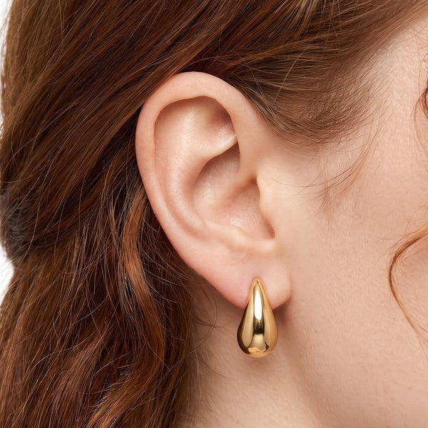 Close-up of the Lelice Ava Curved Hoops in gold on the ear