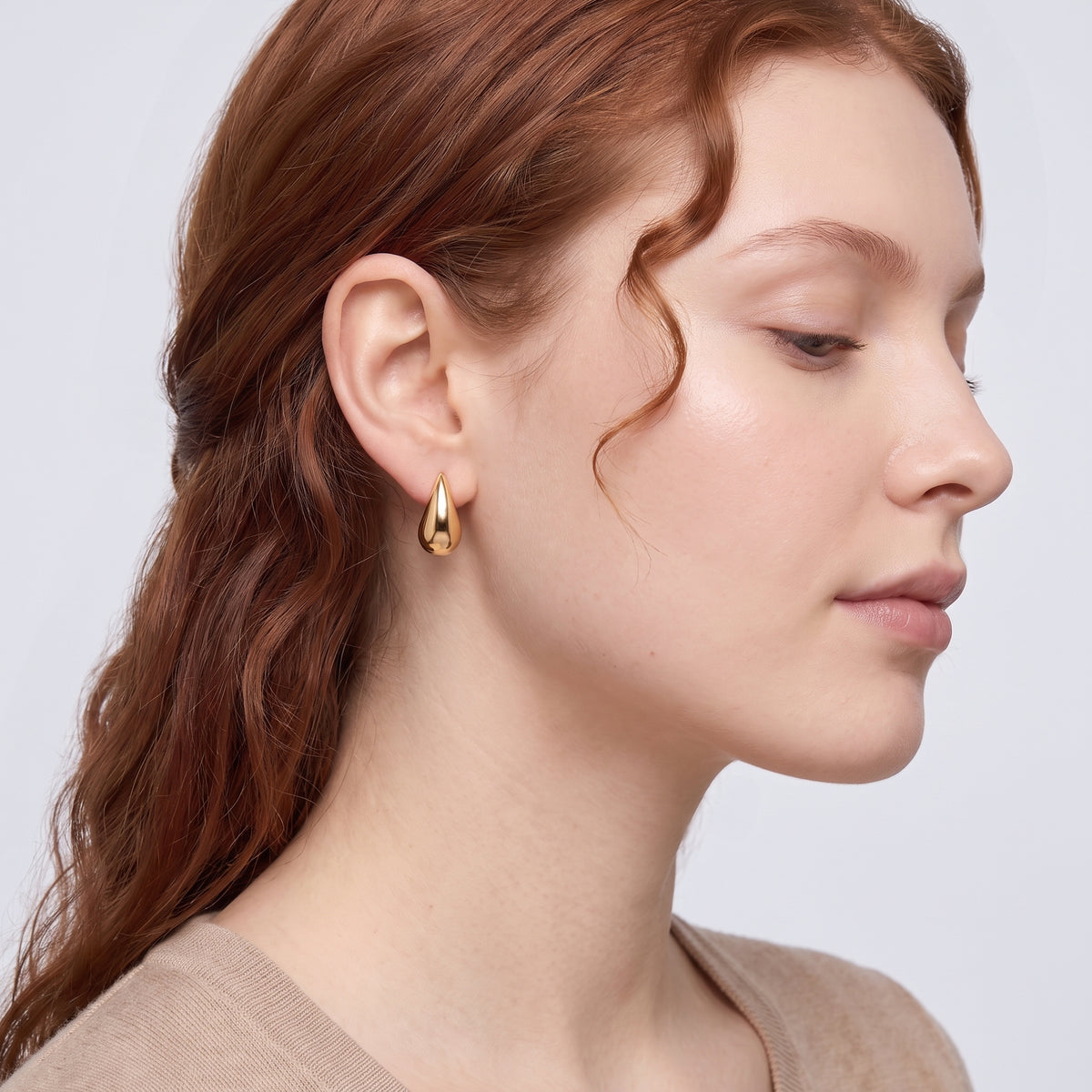 Model wearing the Lelice Ava Curved Hoops in gold, sculpted side profile