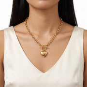 Close-up of the Lelice Bea Chunky Heart Necklace in gold at the collarbone