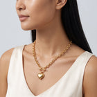 Three-quarter profile of a woman wearing the Bea Chunky Heart Necklace