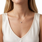 Close-up of the Lelice Beatrice Circle Necklace in gold at the collarbone