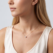 Woman in soft side light wearing the Beatrice Circle Necklace