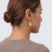 Model wearing the Lelice Brigitte Pearl Earrings in gold, low bun, ear and neck