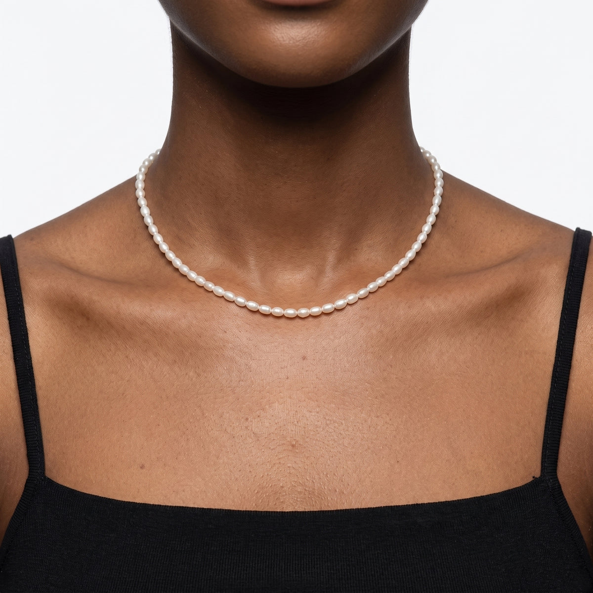 Close-up of the Lelice Camille Pearl Choker in gold at the collarbone