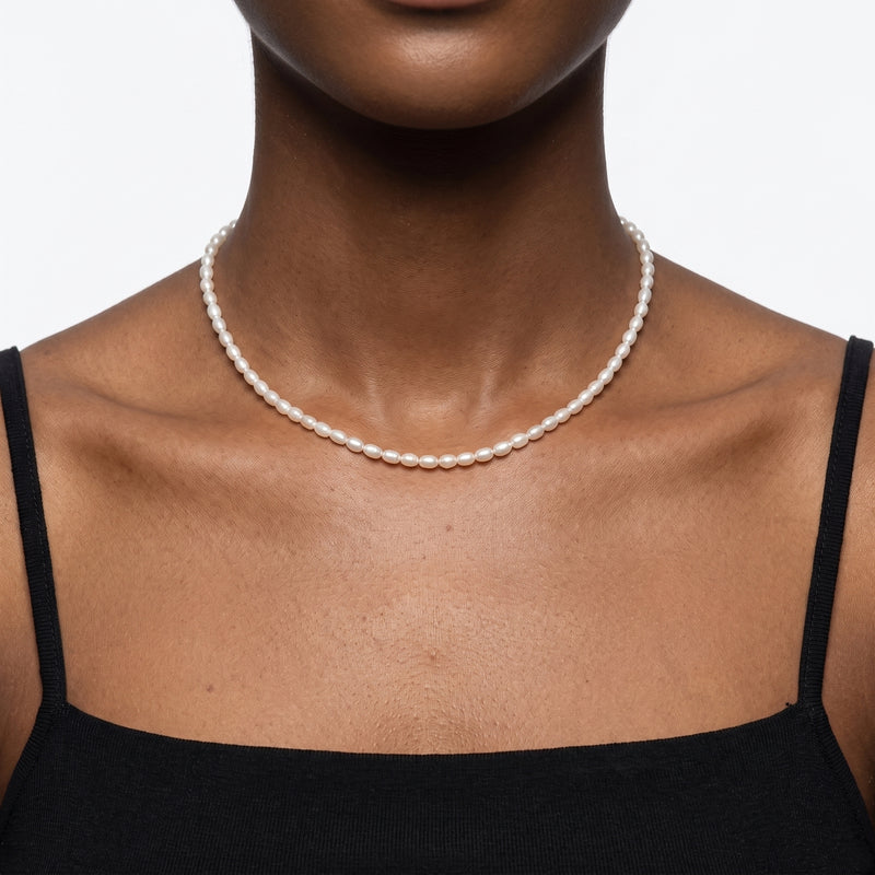 Close-up of the Lelice Camille Pearl Choker in gold at the collarbone