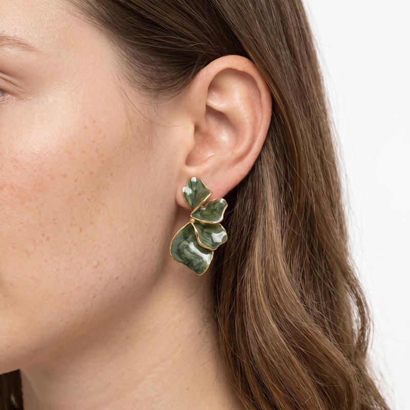 Close-up of the Lelice Capucine Green Petal Earrings in gold on the ear
