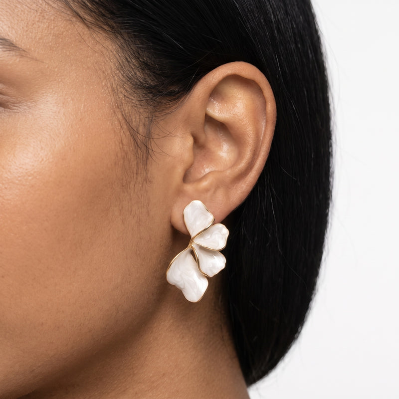 Close-up of the Lelice Capucine White Petal Earrings in gold on the ear