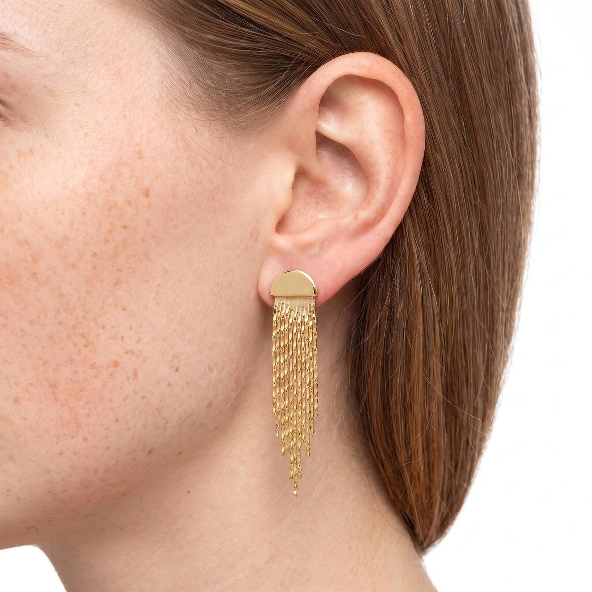 Close-up of the Lelice Cascade Earrings in gold on the ear