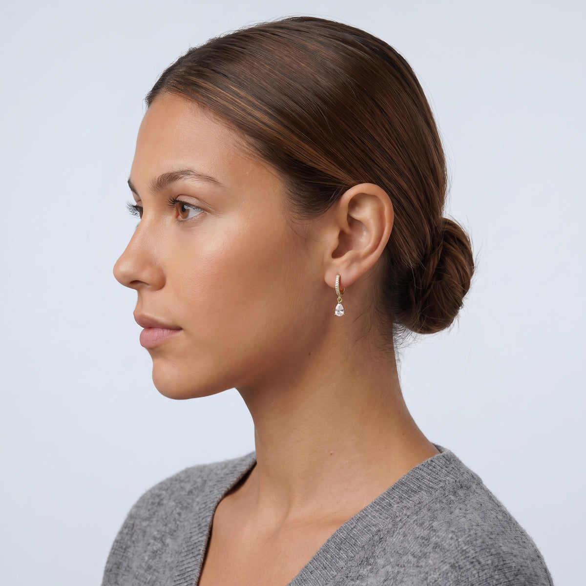 Model wearing the Lelice Céleste Sparkle Hoops in gold, slicked-back profile