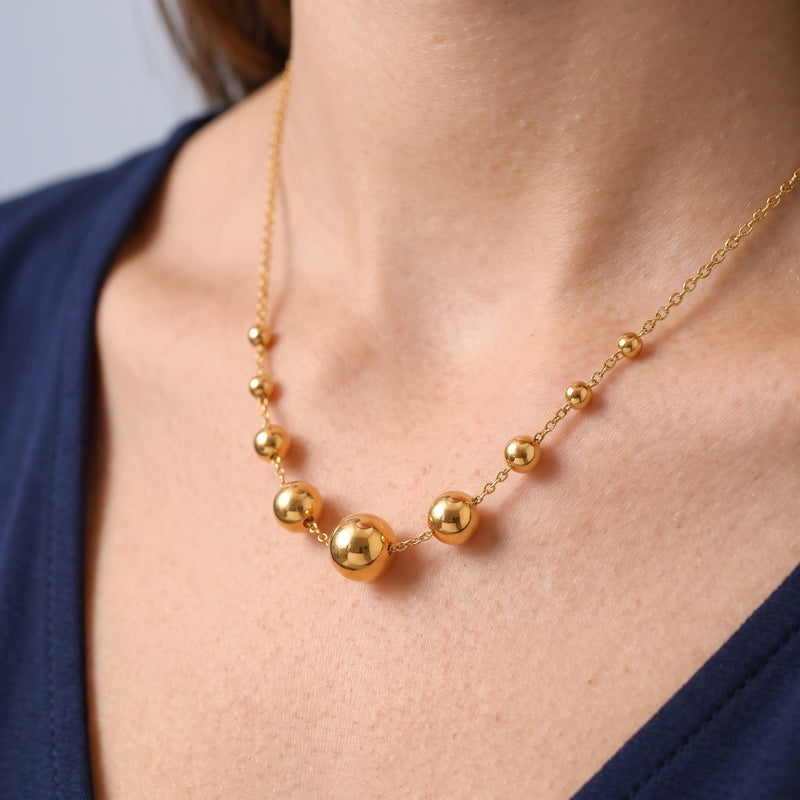 Close-up of the Celeste Sphere Necklace resting on the skin