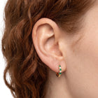 Close-up of the Lelice Celine Crystal Hoops in gold on the ear
