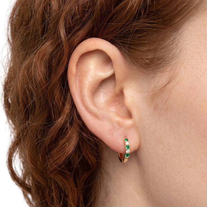 Close-up of the Lelice Celine Crystal Hoops in gold on the ear