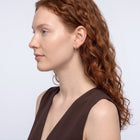 Model wearing the Lelice Celine Crystal Hoops in gold, sculpted side profile