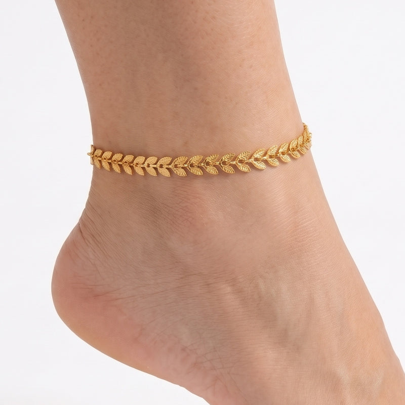 Close-up of the Lelice Celine Timeless Anklet in gold on a woman's ankle