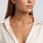 Shoulders and neckline of a woman wearing the Cleo Fine Choker Necklace