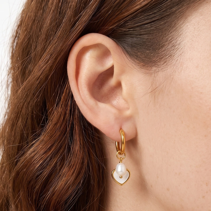 Close-up of the Lelice Cleo Pearl Hoops in gold on the ear