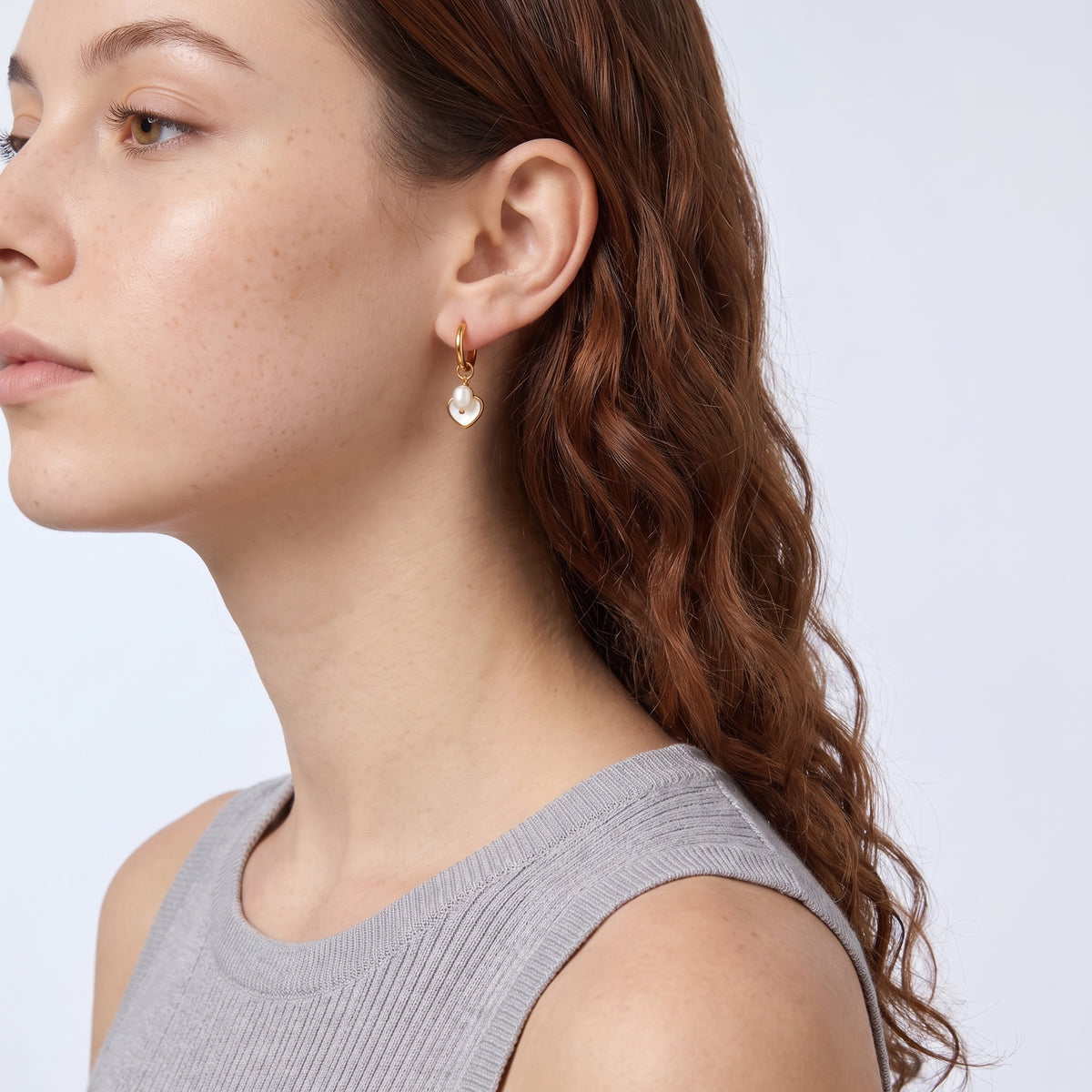 Model wearing the Lelice Cleo Pearl Hoops in gold, sculpted side profile