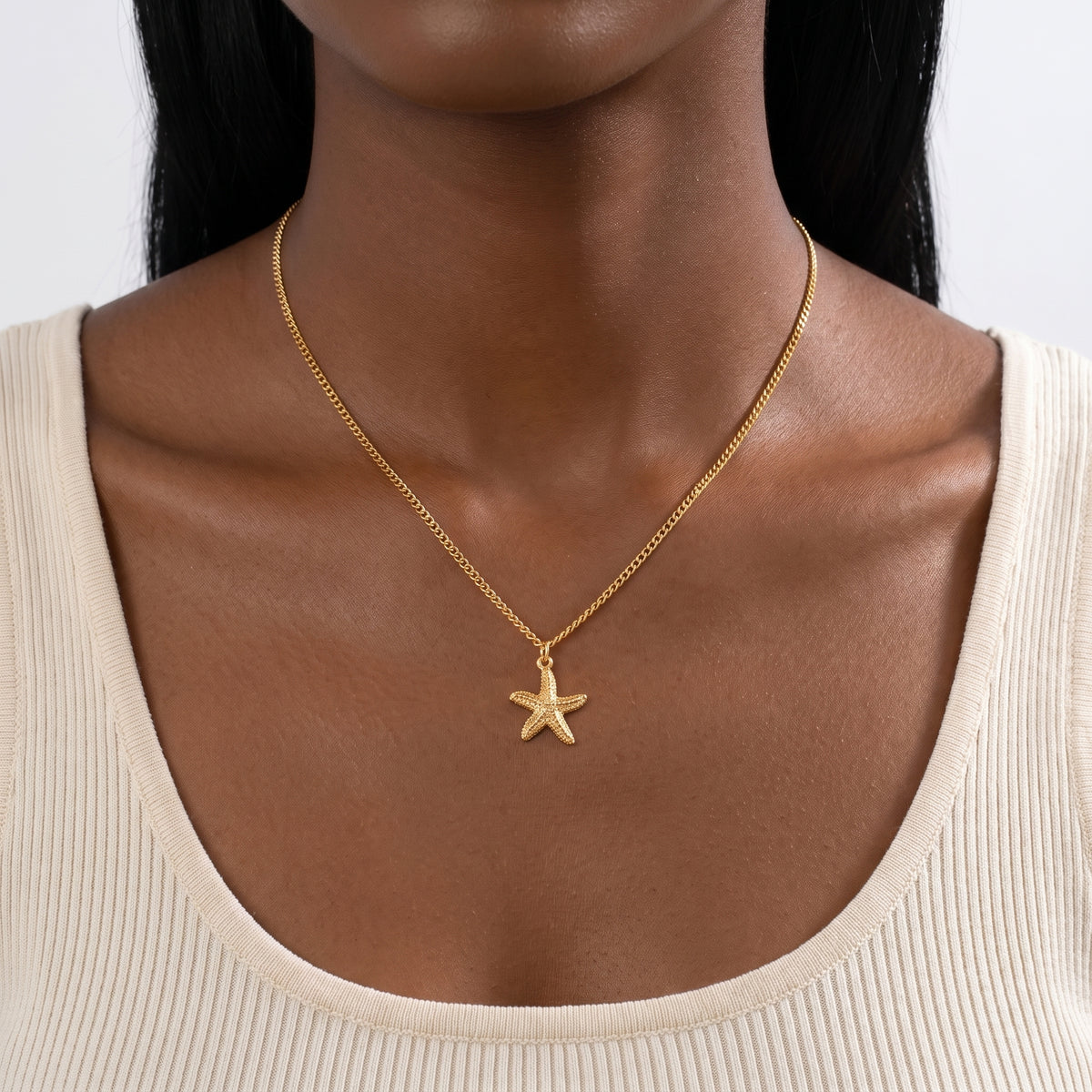 Close-up of the Lelice Coastal Tide Necklace in gold at the collarbone