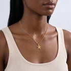 Woman turned three-quarters wearing the Coastal Tide Necklace