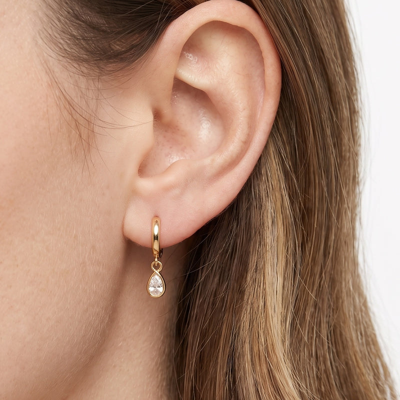 Close-up of the Lelice Coco Gold Teardrop Huggies on the ear