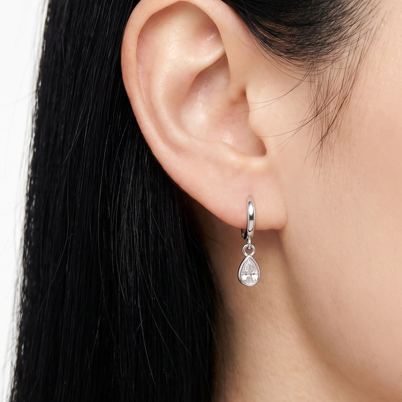 Close-up of the Lelice Coco Silver Teardrop Huggies on the ear
