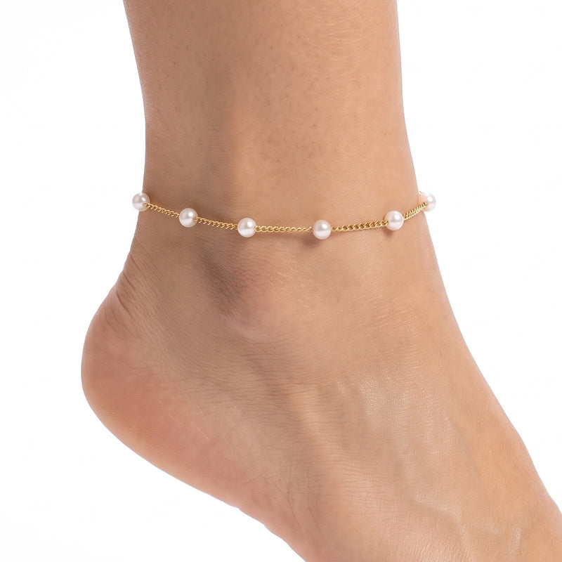 Close-up of the Lelice Colette Pearl Anklet in gold on a woman's ankle
