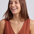 Laughing woman wearing the Constance Crystal Station Necklace