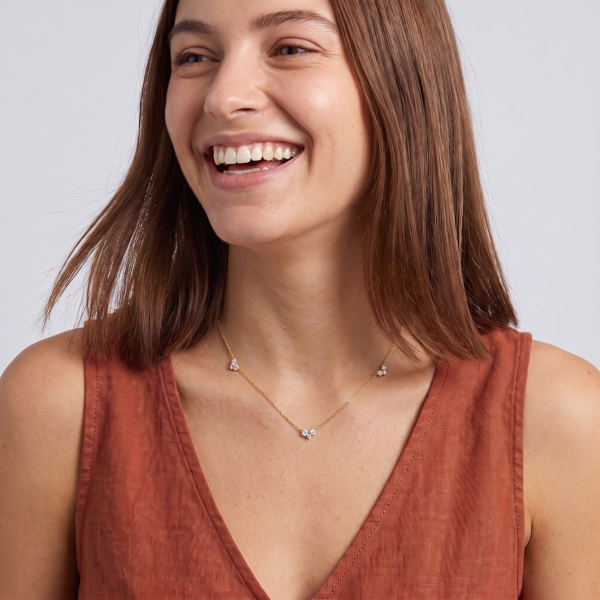 Laughing woman wearing the Constance Crystal Station Necklace