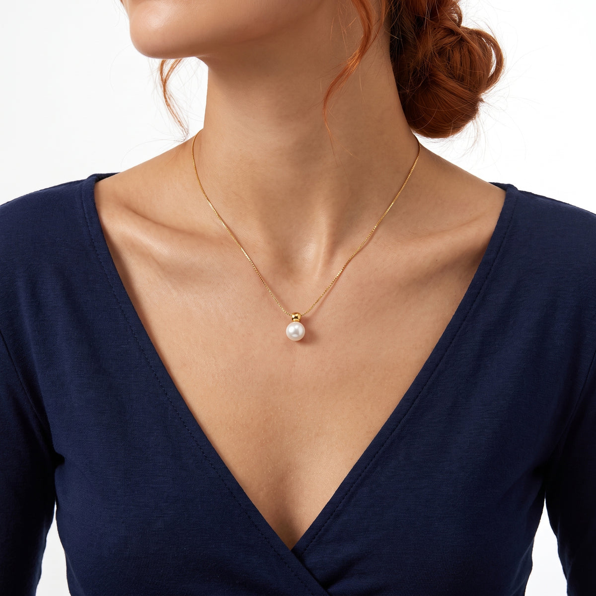 Close-up of the Lelice Cora Pearl Drop Necklace in gold at the collarbone