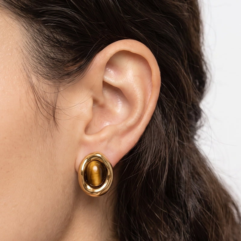 Close-up of the Lelice Corinne Tiger's Eye Studs in gold on the ear