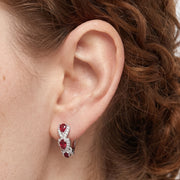 Close-up of the Lelice Crimson Ruby Hoops in silver on the ear