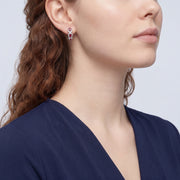 Model wearing the Lelice Crimson Ruby Hoops in silver, sculpted side profile
