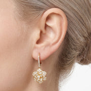 Close-up of the Lelice Crystal Rosette Gold Earrings on the ear
