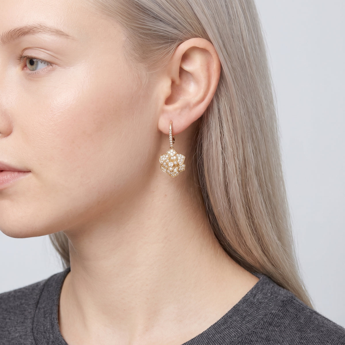 Model wearing the Lelice Crystal Rosette Gold Earrings, ear and jaw, slightly wider